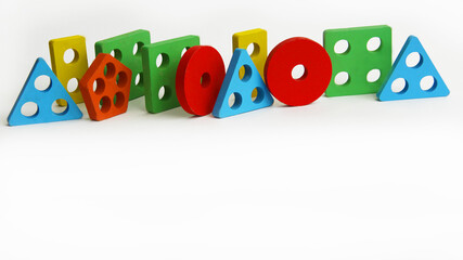 colorful geometric shapes of different colors stand on a white background