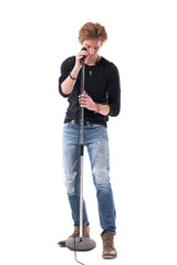 Young stylish man rocker prepare and adjusting microphone before concert. Full body length isolated on white background.