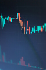 Abstract financial trading graphs and digital number of foreign exchange market trading on monitor. Background of gold and blue digital chart to represent stock market trend.