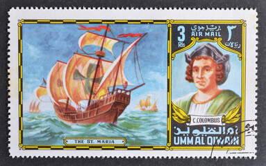 Cancelled postage stamp printed by Umm al Qiwain, that shows Christopher Columbus and The Saint...