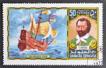 Cancelled postage stamp printed by Umm al Qiwain, that shows Drake and The Golden Hindsailing ship,...