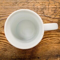 Empty white cup on the wooden table