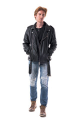 Fototapeta premium Thoughtful cool stylish rocker or biker man walking with hands in pockets. Full body length isolated on white background.