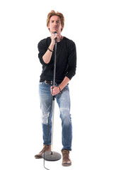 Cool macho stylish rocker singer holding microphone on stand. Full body length isolated on white...