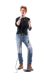 Handsome confident rock music singer holding microphone looking at camera. Full body length...