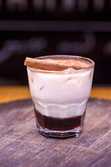 Alcoholic cocktail on wooden board