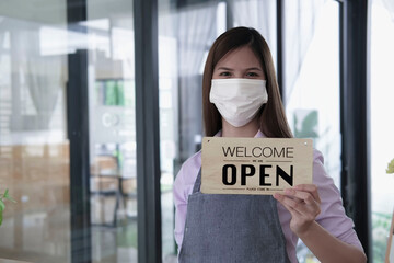 Open. barista, Coffee shop owner with face mask turning open sign board on glass door cafe shop, cafe restaurant, retail store, small business owner, open and close label concept