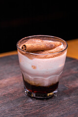 Alcoholic cocktail on wooden board