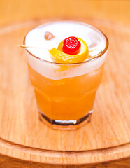 Alcoholic cocktail on wooden board