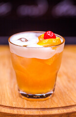 Alcoholic cocktail on wooden board