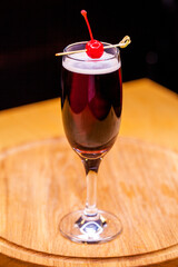 Alcoholic cocktail on wooden board