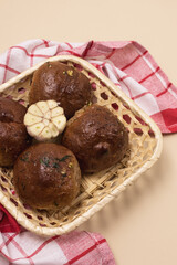Garlic Bread Buns in Straw Basket Bread Rolls with Garlic Yellow Background Top View