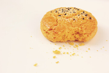 Yellow cookies sprinkled with black and white sesame seeds.