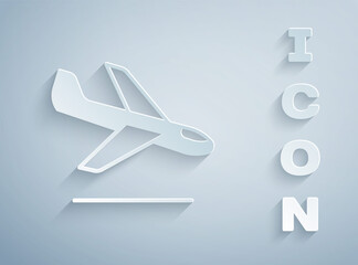 Paper cut Plane landing icon isolated on grey background. Airplane transport symbol. Paper art style. Vector