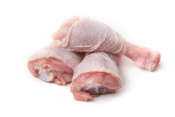 Raw chicken legs with skin on a white background.