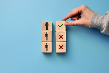 Wooden cubes with drawings of people and a sign of choice . Symbol of potential customers ' choice for business