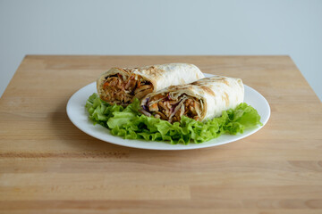 A cut kebab, shawarma, with grilled meal and vegetables