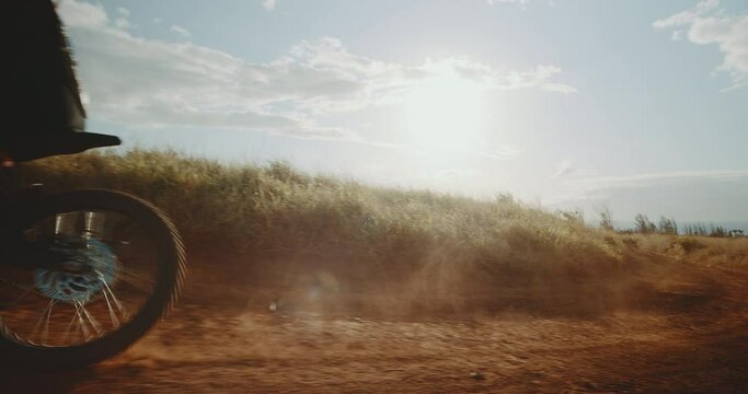 Woman riding her electric dirt bike at sunset, futuristic electric dirt bike, adventure active lifestyle, cinematic slow motion