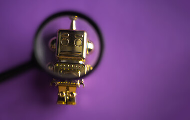 toy golden robot with magnifying glass