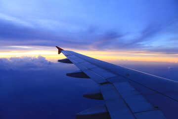 The beautiful colored sky from the view outside the plane window.