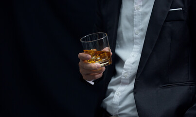 Man wearing a suit whiskey glass of liquor 