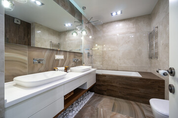 Exclusive bathroom with glass shower, basin and big mirror
