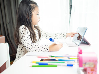 Asian children girl using tablet study online