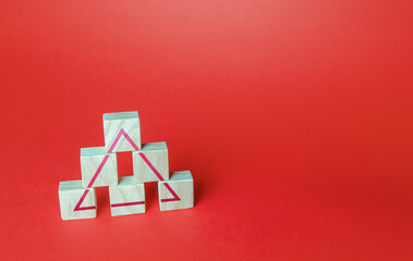 Wooden blocks make a triangle. Society or business ranking system concept. Abstraction of solidity....