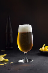 Cold Lager beer and potato crisps on table. 