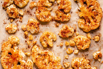 Cauliflower steak with spices cooked in the oven, top view.