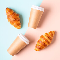 Coffee to go in a paper cup with croissants.