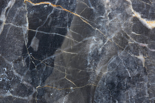 White and gold patterned detailed of gray marble texture. Abstract dark background.