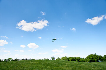 Obraz na płótnie Canvas Toy airplane glider flies into the sky, in the summer in the park