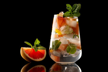 orange and mint slice and glass with orange and mint ice drink isolated on black background