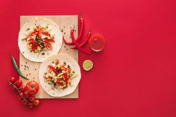 Board with tasty tacos and vegetables on color background