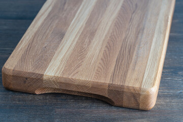 Wooden cutting board on wooden table background