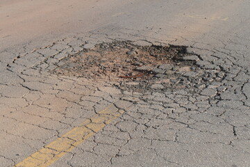 Large pothole in the middle of the road, a big danger for traffic. Federal road BR 174, state of Amazonas, Brazil.