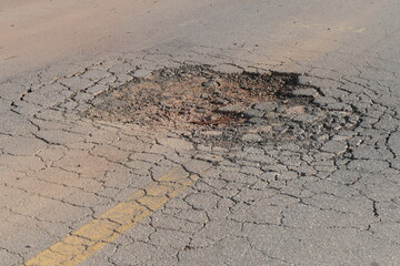 Large pothole in the middle of the road, a big danger for traffic. Federal road BR 174, state of Amazonas, Brazil. © juerginho