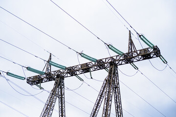 Fototapeta premium power line close-up against the sky. a system of power equipment designed for the transmission of electricity by means of an electric current.