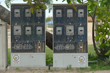 Electricity meters in gray switch boxes on a public street in Jerisoacoara, Ceará State, Brazil.