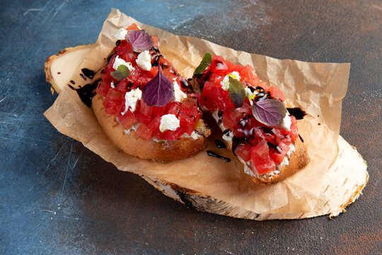 bruschets with tomatoes on a rustic plate. Close-up.