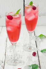 Summer cranberry and mint cocktail with ice. Vertical photo.