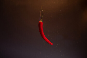 Fiery red chili peppers in sparks.
