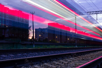 A passing train left traces of headlights Photo taken on the tracks in Moscow, electric train, light, city, spring, ball, 2021.