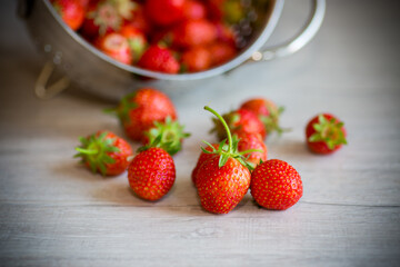 red ripe natural strawberries on a wooden table