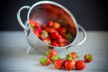 red ripe natural strawberries on a wooden table