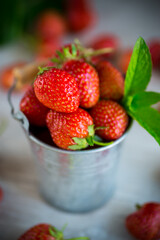 red ripe natural strawberries on a wooden table