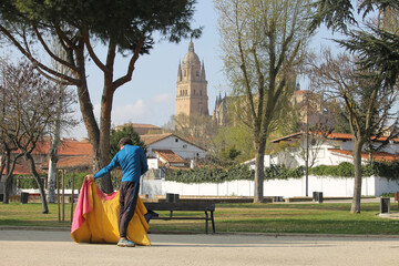 Man doing bullfighting practices in a park in the city of Salamanca (Spain)