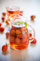 Sweet refreshing berry compote of ripe strawberries in a decanter