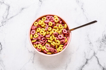 Bowl with tasty cereal rings on light background